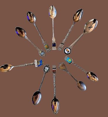 A collection of souvenir spoons representing various historical and geographical destinations 