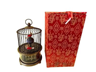 A vintage mechanical table clock in the shape of a birdcage. This is a decorative clock made of 