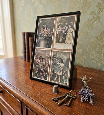 A designed frame containing four original antique French postcards (RPPC), dating from the 