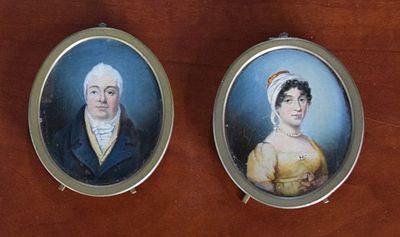 Two Miniature Portraits. Two miniature portraits of a man and his wife in brass oval frames with 