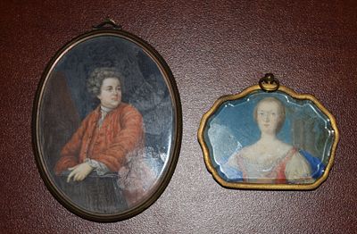 Two Miniature Portraits. Two miniature portraits of a man and lady with brass frames. The 