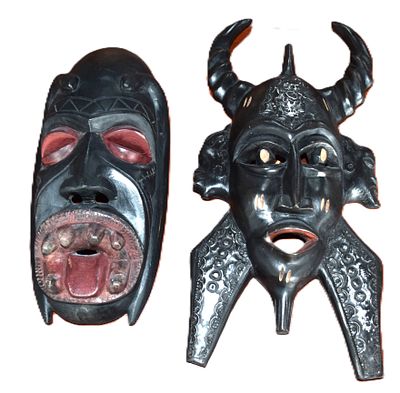 Two Western African Tribal Masks. Two Western African hand-carved sese wood tribal masks, one a 