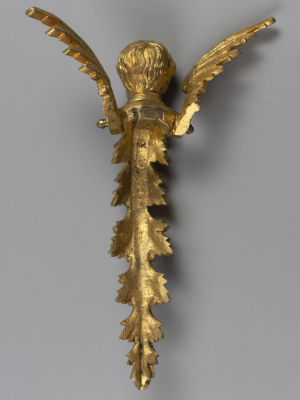 Накладка (деталь) с головой путти. Бронза, золочение. Кон. XIX в. Размер 21х15х7 см. 
Общие 