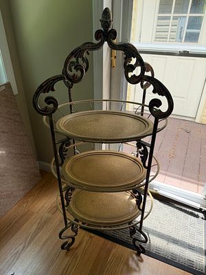 Metal Three Tiered Plant Stand. Excellent condition. Measures 46" x 22" x 17".