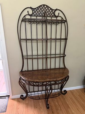 Iron Bakers Rack. Excellent condition. Features a half moon wood table, three glass shelves 
