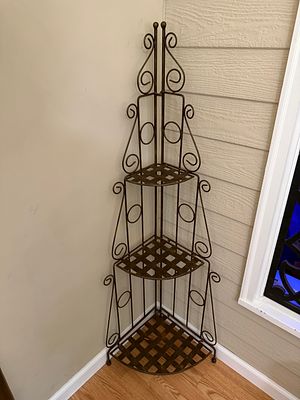Metal Three Tier Corner Shelf. Excellent condition. Folds for easy transportation. Measures 54 