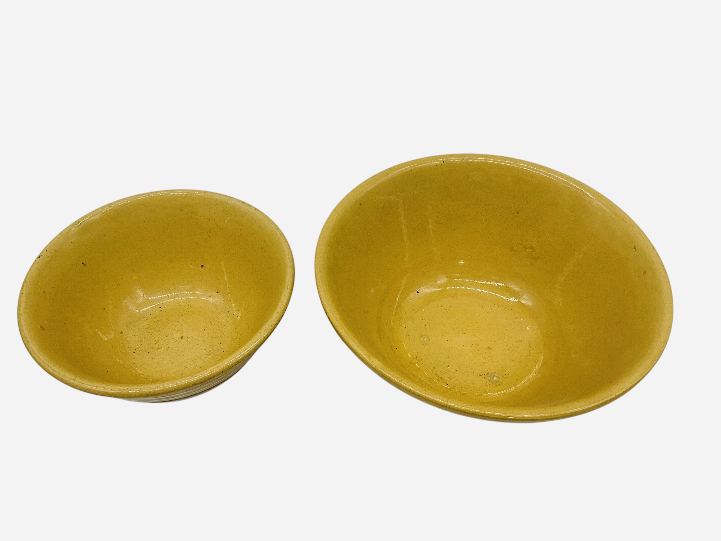 Two Graduated Yellow Ware Bowls