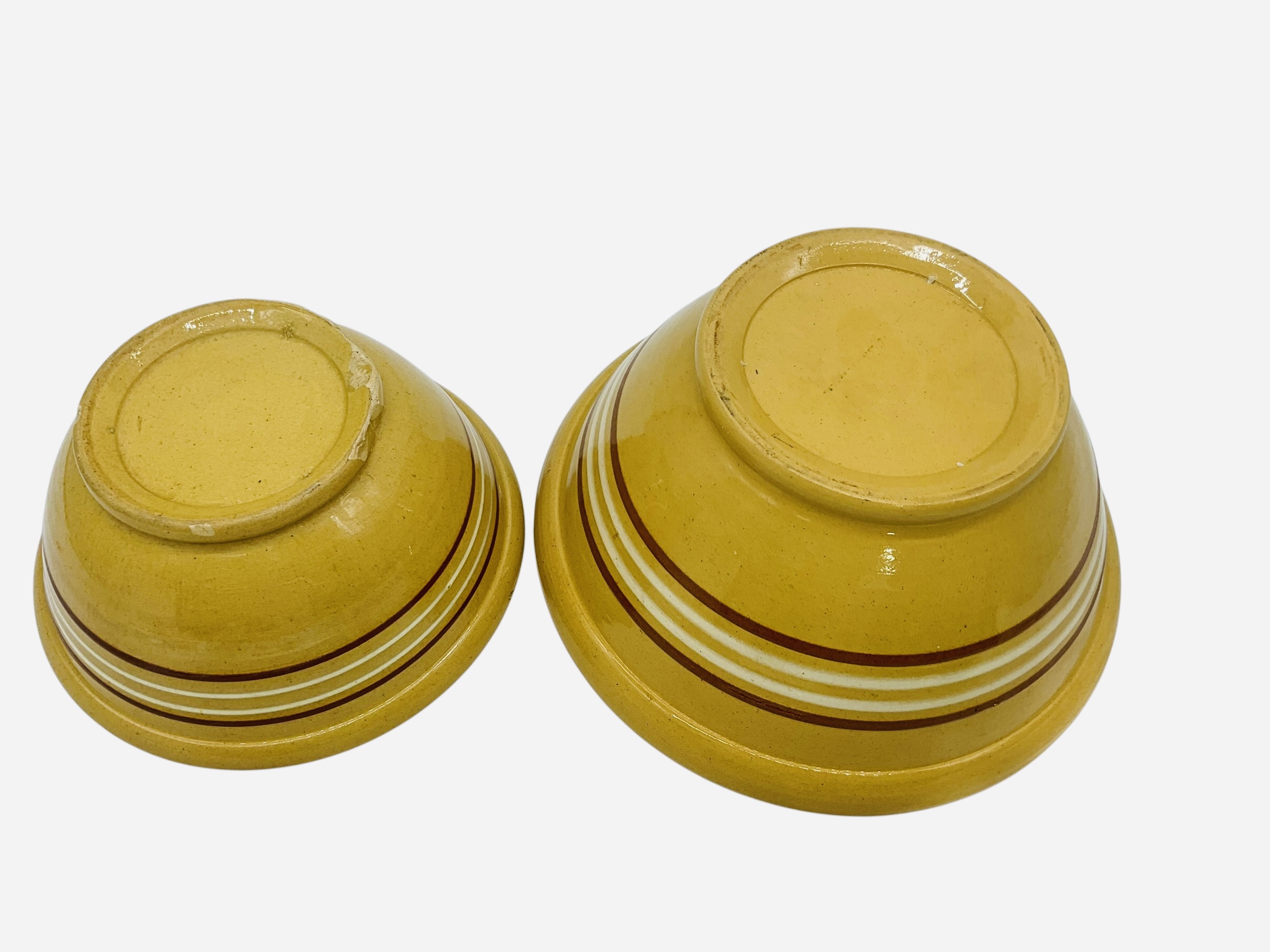 Two Graduated Yellow Ware Bowls