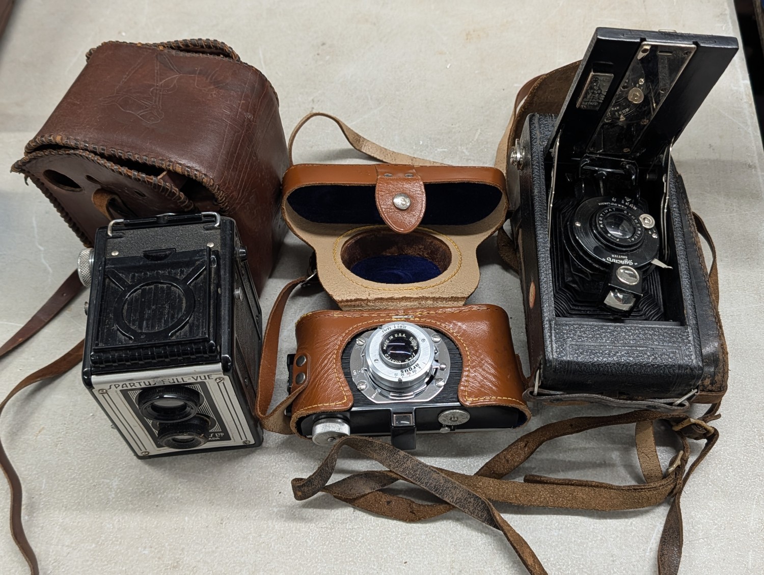 A Trio of Vintage Cameras including Spartus Full-Vue, Argus 35mm, and H.B.M