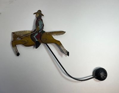 Детская игрушка "Ковбой". Металл. Игрушка с балансиром. 1920-30гг.. Размер: 19х26,5см.