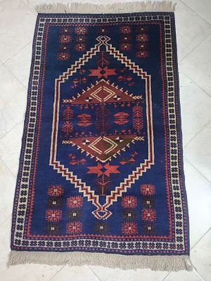 שטיח אפגני 
ארוג בעבודת יד 
בגווני כחול כהה עם דוגמה גאומטרית מרכזית ומדליון משונן בצבעי אדום 