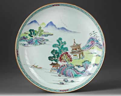 A CHINESE FAMILLE ROSE DISH, 18TH CENTURY. A famille rose dish decorated with a pavilion in a 