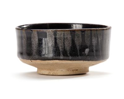 A CHINESE HENAN BRUSH WASHER, SONG DYNASTY (960-1279). A Chinese Henan brush washer resting on a 