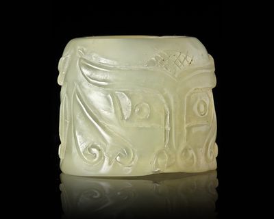 A CHINESE JADE ARCHER'S RING, 20TH CENTURY. A Chinese pale celadon jade ring carved and incised 