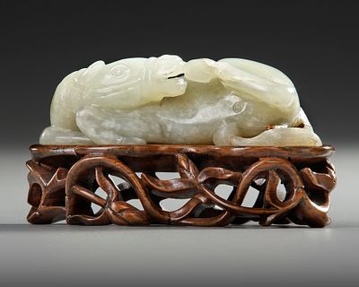 A CHINESE GRAYISH JADE CARVING OF A HORSE, 19TH CENTURY. The animal skillfully carved recumbent 