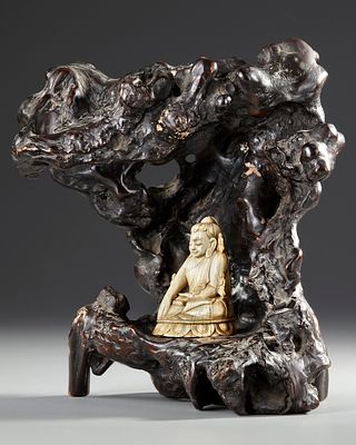 A CHINESE CARVED BONE FIGURE OF A BUDDHA WITH A CARVED WOODEN STAND. A Chinese bone figure of a 