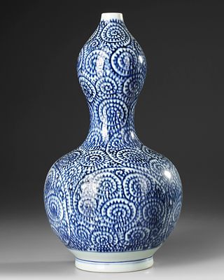 A JAPANESE BLUE AND WHITE DOUBLE- GOURD SAKE VASE, WITH OCTOPUS ANS KARAKUSA, LATE EDO PERIOD 