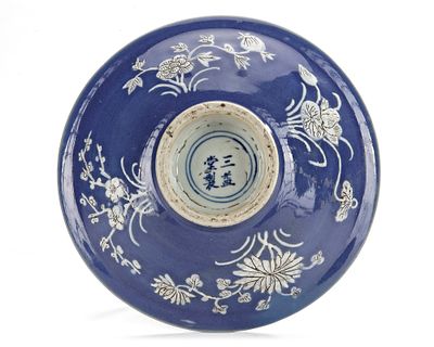 A CHINESE BLUE-GROUND SLIP DECORATED BOWL, 17TH CENTURY. The bowl with flared sides and everted 