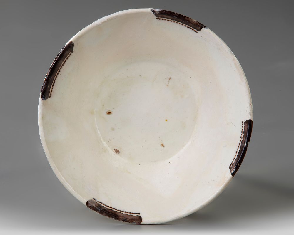 A NISHAPUR POTTERY SAMANID BOWL, 9TH-10TH CENTURY. Standing on a small uncovered foot with 