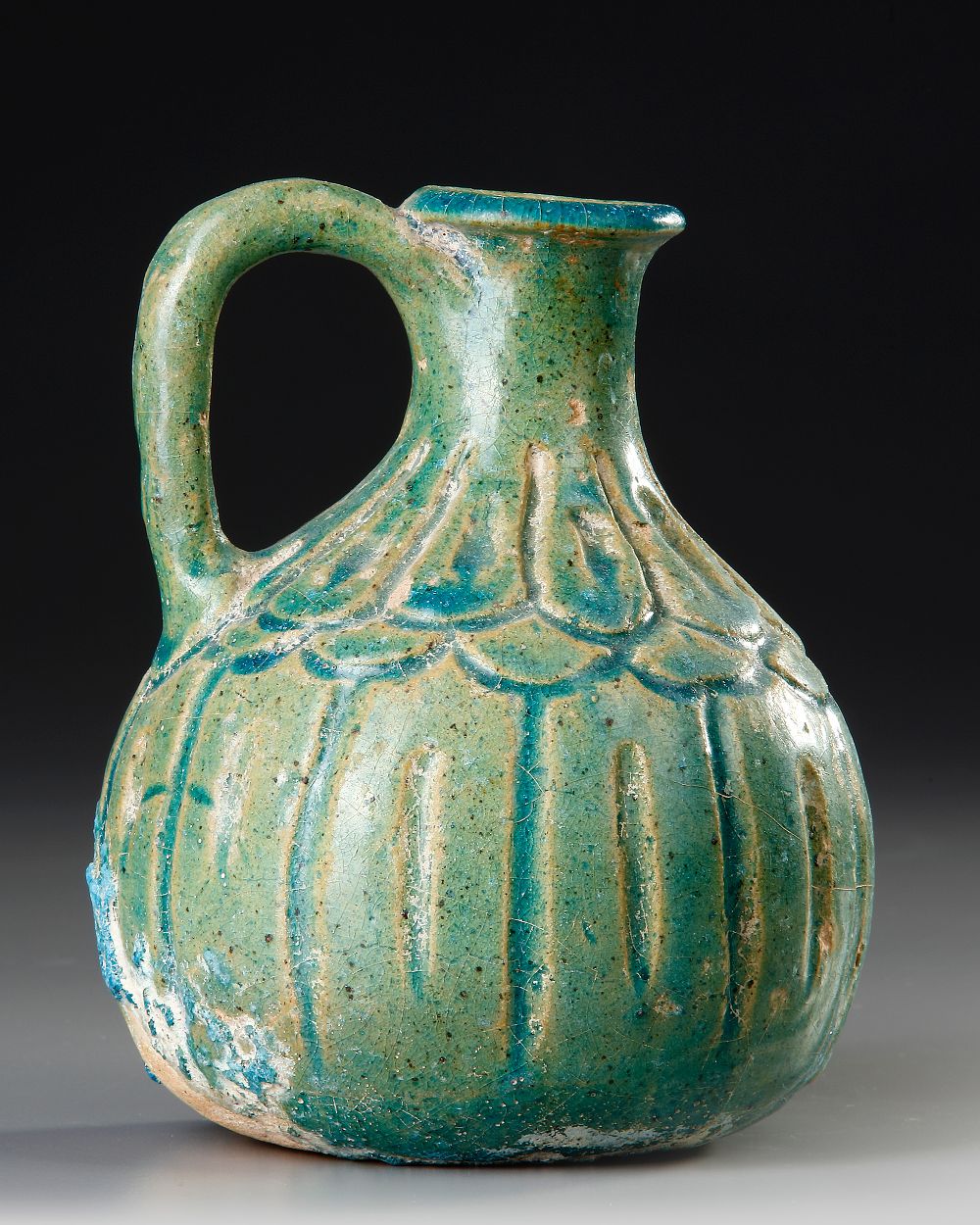 A TURQUOISE BLUE GLAZED POTTERY JUG, PERSIA, 10TH-11TH CENTURY. A Persian jug with globular 