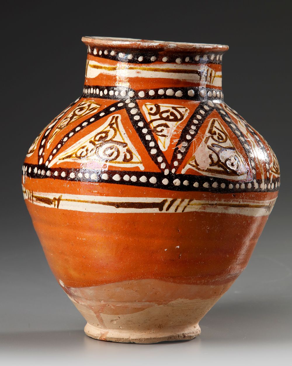 A SAMANID SLIP-PAINTED POTTERY JAR, 10TH-11TH CENTURY. Decorated in manganese brown and cream 