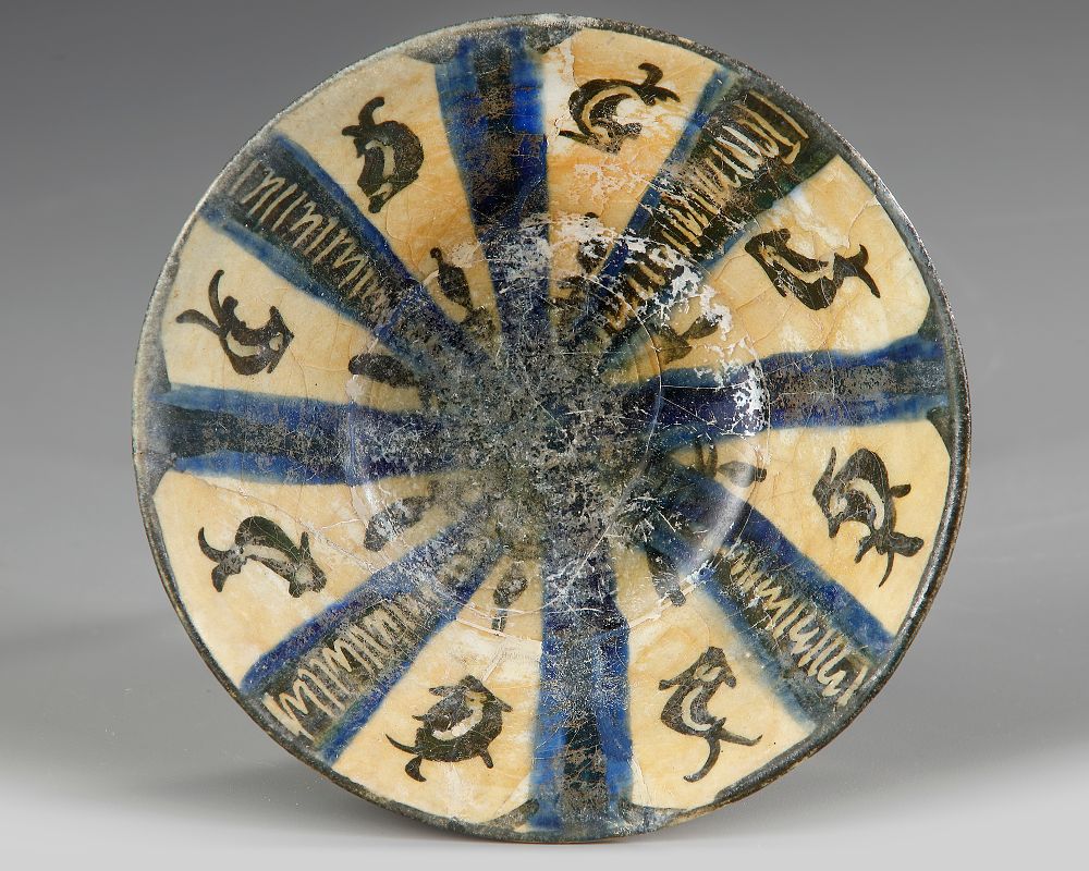 A KASHAN POTTERY BOWL, PERSIA, 13TH - 14TH CENTURY. Standing on small foot with a slightly 