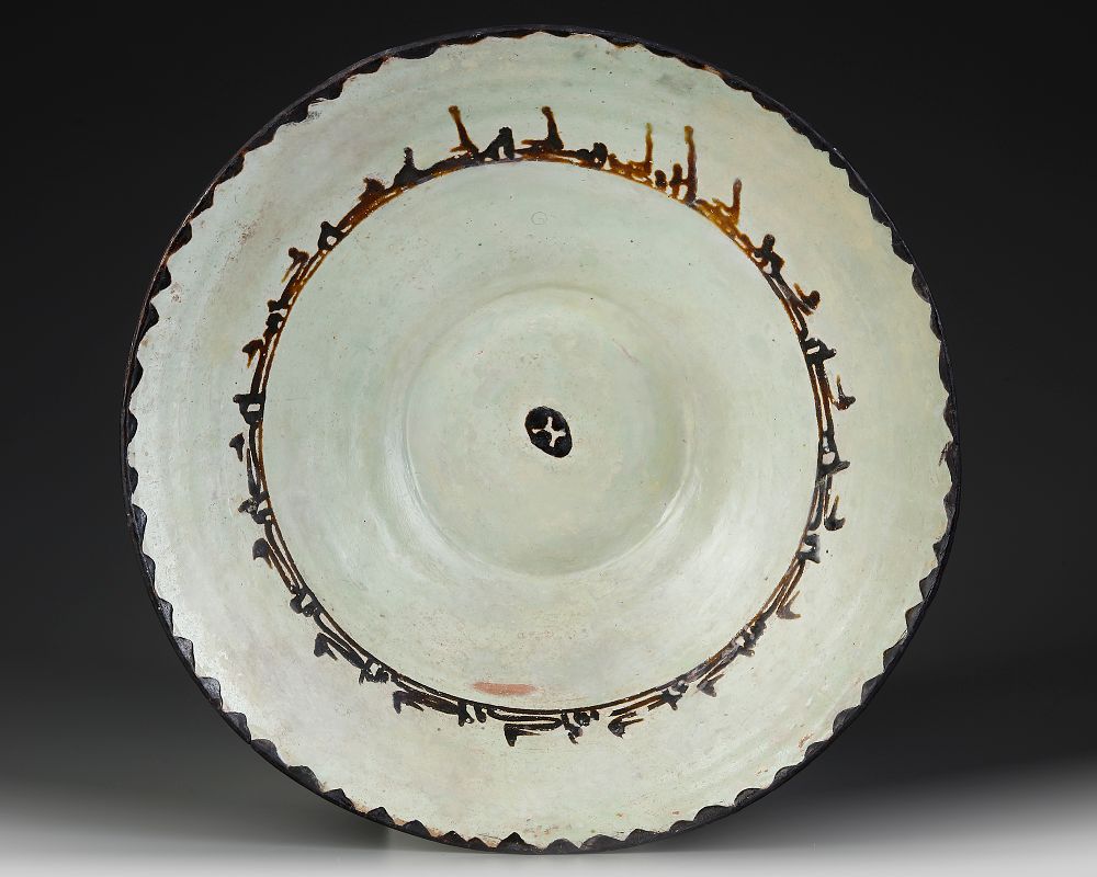 A SAMANID SLIP-PAINTED POTTERY BOWL, PERSIA, 10TH CENTURY. Of conical form on a short foot 