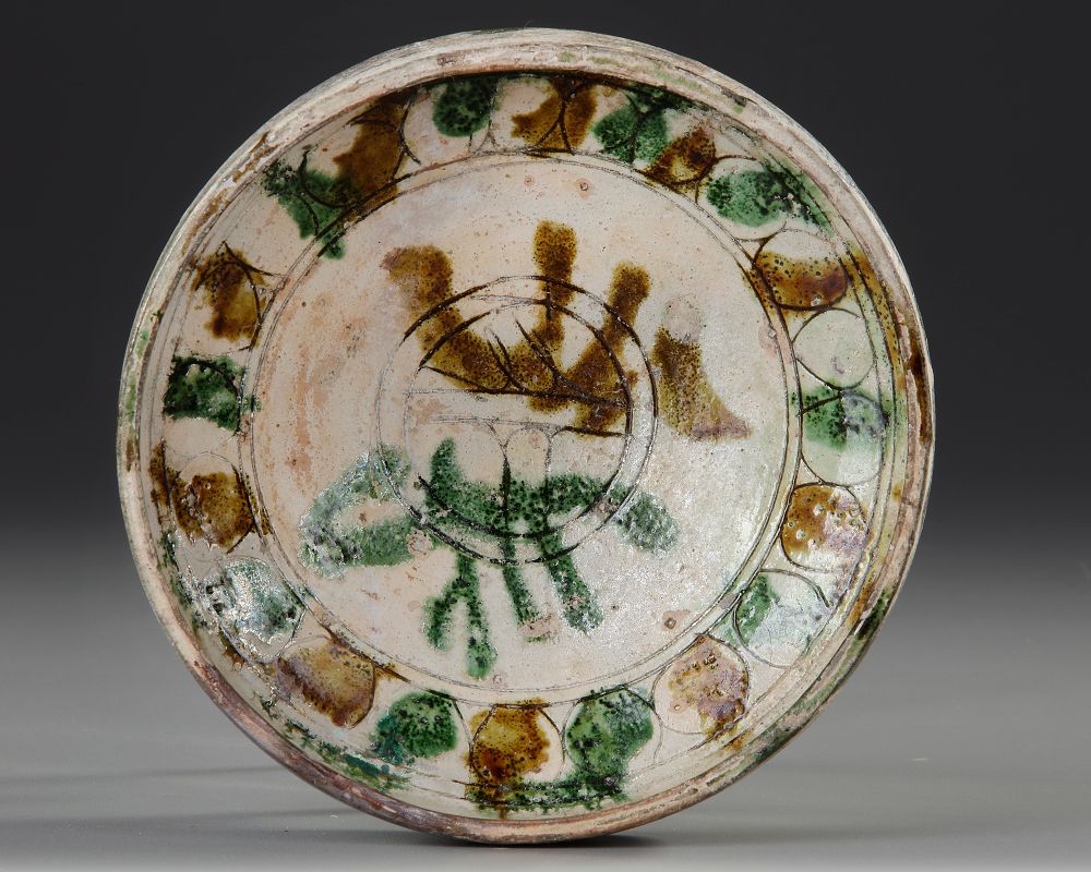 A SGRAFFITO SPLASHWARE POTTERY BOWL, PERSIA, NISHAPUR, 10TH CENTURY. A pottery bowl of rounded 