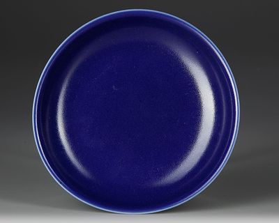 CHINESE BLUE-GLAZED DISH, 19TH–20TH CENTURY. A refined porcelain dish covered in deep 