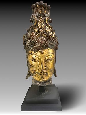 LARGE GILT BRONZE HEAD OF GUANYIN, MING DYNASTY OR LATER. This impressive sculpture represents 