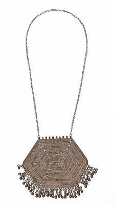 A SILVER NECKLACE, OMAN, 19TH CENTURY. Features a large hexagonal pendant richly decorated with 