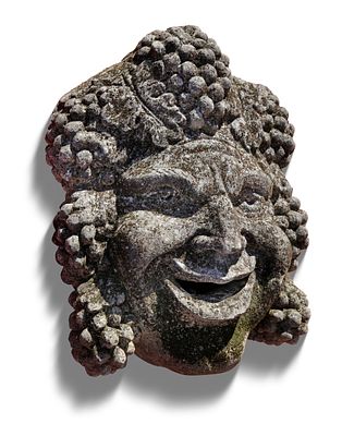 A SCULPTED CARVED LIMESTONE BACCHUS WALL FOUNTAIN MASK, 20TH CENTURY. Height 48 cm. Width 38 cm.