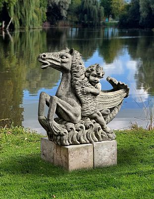 A SCULPTED LIMESTONE MODEL OF A HIPPOCAMPUS, SECOND HALF 20TH CENTURY. Modelled with a putto 
