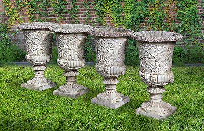 A SET OF FOUR WHITE COMPOSITION STONE GARDEN URNS IN THE ROMANTIC CLASSICAL MANNER, SECOND HALF 