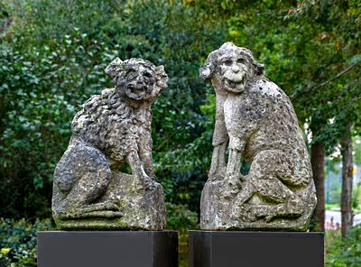 A PAIR OF CARVED LIMESTONE DOGS ('POORTWACHTERS'), FRANCE, 18TH CENTURY. Possibly originally 
