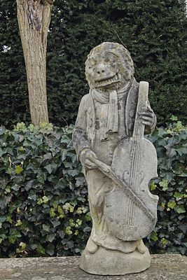A CARVED LIMESTONE CLOTHED MONKEY PLAYING THE VIOLIN, 18TH CENTURY. This 18th-century artwork is 