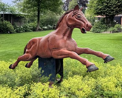 A RARE TOLE-PEINTE ALUMINIUM CAROUSEL HORSE, MID 20TH CENTURY. Set on a iron rocker base and 