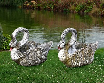 A PAIR OF COMPOSITION STONE PLANTERS MODELED AS SWANS, SECOND HALF 20TH CENTURY. Height 55 cm. 