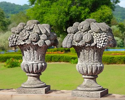 A PAIR OF LIMESTONE PIER FINIALS IN THE FORM OF FLOWER/FRUIT BASKETS, 20TH CENTURY. Height 72 