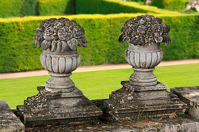 A PAIR OF CARVED LIMESTONE PIER FINIALS IN THE FORM OF FRUITING BASKETS, LATE 19TH OR EARLY 