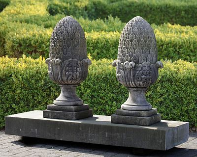 A PAIR OF CARVED LIMESTONE PIER FINIALS, 20TH CENTURY. Height 80 cm. Plinth 30 by 30 cm.