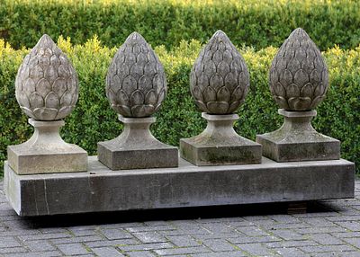 A SET OF FOUR CARVED LIMESTONE PIER FINIALS, 20TH CENTURY. Height 55 cm.