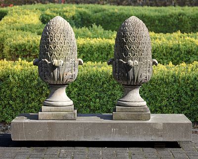 A PAIR OF CARVED LIMESTONE PIER FINIALS, 20TH CENTURY. Height 80 cm. Plinth 30 by 30 cm.