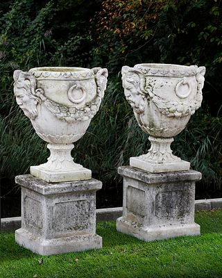A PAIR OF COMPOSTION STONE GARDEN URNS, LATE 20TH CENTURY. Each with an everted rim, with horned 