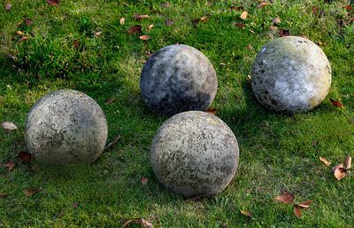 A GROUP OF FOUR LIMESTONE ORNAMENTAL SPHERES, LATE 20TH CENTURY. Probably lawn markers. Each 