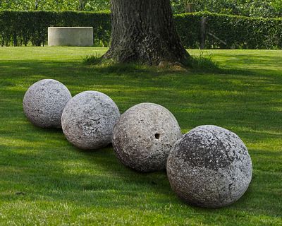 A GROUP OF FOUR CARVED STONE ORNAMENTAL SPHERES, LATE 18TH CENTURY. Probably lawn markers 
