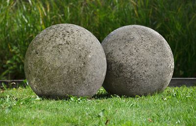 A LARGE PAIR OF LIMESTONE ORNAMENTAL SPHERES, LATE 20TH CENTURY. Probably lawn markers. Each 