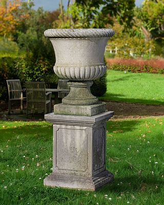 A CARVED LIMESTONE GARDEN URN, 20TH CENTURY. With eververted cable moulded rim above a semi 