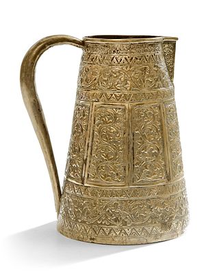 A MALAY SILVER JUG, 19TH CENTURY. Decorated with intricate floral and geometric engravings in 
