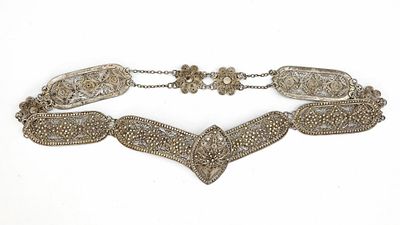AN OTTOMAN SILVER BELT, 19TH CENTURY. Composed of intricately pierced floral panels linked 